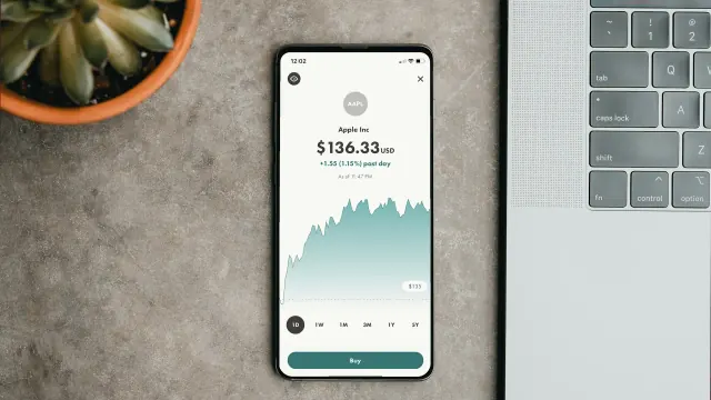 A phone savings chart beside a laptop shows a 1 100 money saving chart.