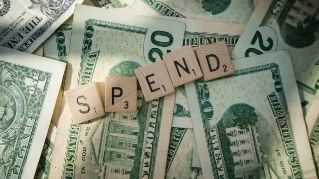 Scrabble tiles spell spend across cash for how to stop spending money.